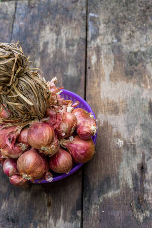 The red onion (shallot) on the old wooden backgroud