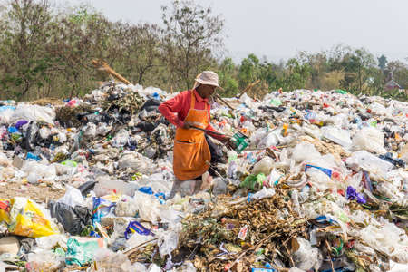 Nong Bua Lam Phu  province, THAILAND. February 5 2019. Waste from household in waste landfill and men worker.のeditorial素材