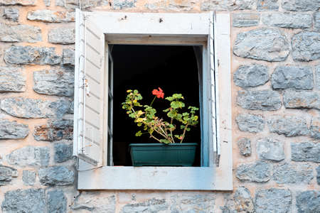 A traditional Mediterranean stone mansion with wooden shutters in a Montenegrin architectural styleの写真素材