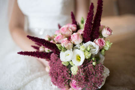 Bride hand hold boho style Bouquet of peach rosesの写真素材