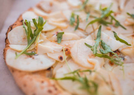 pieces of pizza with a pear close up and blurryの写真素材