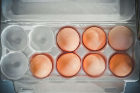 seven Eggs in plastic box. top view