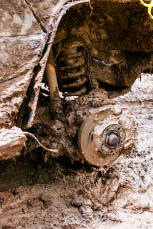 close of view of a very muddy suspension after off road driving through the dirt and mud.の写真素材