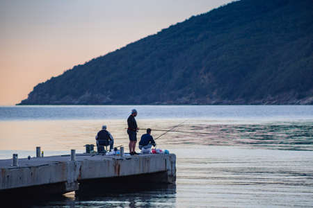 Fishermen on the pier in the early morning.
