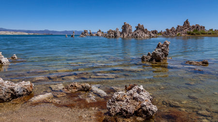 Ondulations on a lake with calcium rocks around and pebbles in the transparent waterの写真素材