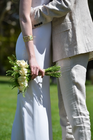 A bride on her wedding day with a white dress and hair extensions and flowersの写真素材