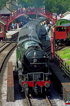 A steam engine pauses at Goathland station on the North Yorkshire steam railway, which often featured in the telivision series Heartbeat のeditorial素材