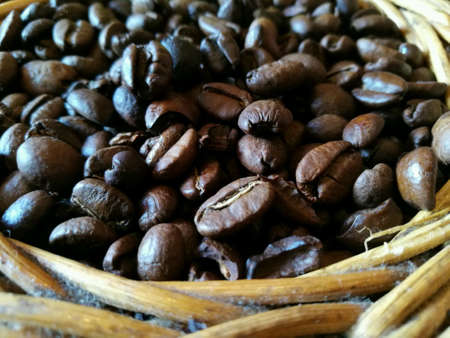 Fresh coffee beans on rattan basketの素材