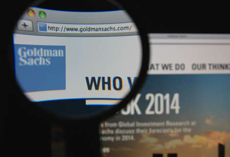 LISBON - JANUARY 22, 2014: Photo of Goldman Sachs homepage on a monitor screen through a magnifying glass.のeditorial素材