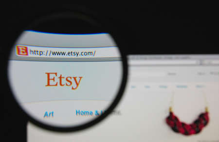 LISBON - JANUARY 22, 2014: Photo of Etsy homepage on a monitor screen through a magnifying glass.