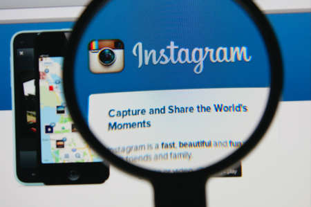 LISBON - JANUARY 22, 2014: Photo of Instagram homepage on a monitor screen through a magnifying...