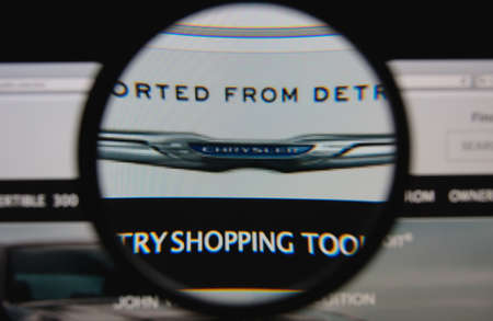 LISBON - JANUARY 29, 2014: Photo of Chrysler homepage on a monitor screen through a magnifying glass.のeditorial素材