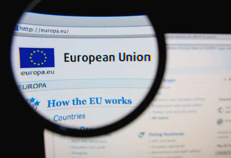 LISBON, PORTUGAL - FEBRUARY 8, 2014: Photo of the European Union homepage on a monitor screen through a magnifying glass.のeditorial素材