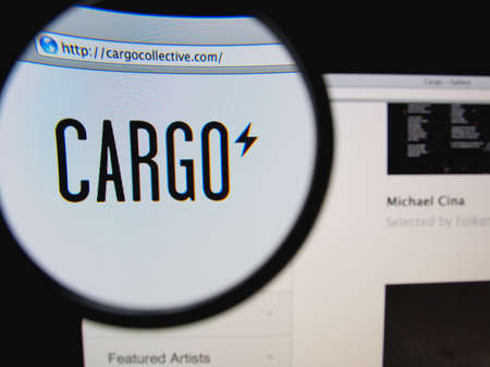 LISBON, PORTUGAL - FEBRUARY 8, 2014: Photo of Cargo homepage on a monitor screen through a magnifying glass.のeditorial素材