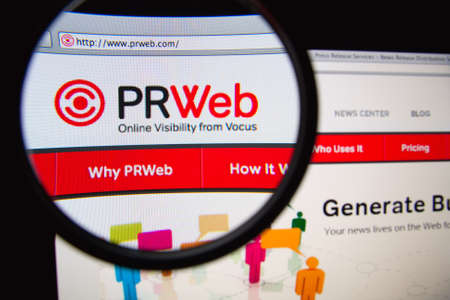LISBON, PORTUGAL - FEBRUARY 19, 2014: Photo of PRWeb press release homepage on a monitor screen through a magnifying glass.のeditorial素材