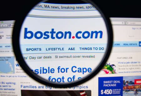 LISBON, PORTUGAL - FEBRUARY 19, 2014: Photo of Boston.com homepage on a monitor screen through a...