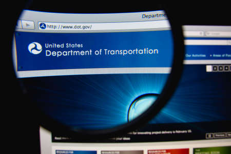 LISBON, PORTUGAL - FEBRUARY 21, 2014: Photo of United States Department of Transportation homepage on a monitor screen through a magnifying glass.のeditorial素材