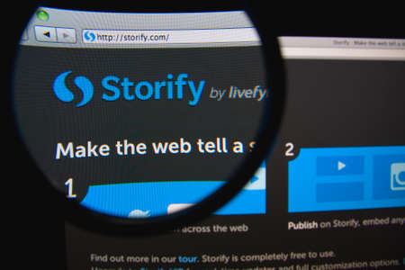 LISBON, PORTUGAL - FEBRUARY 21, 2014: Storify homepage through a magnifying glass.のeditorial素材