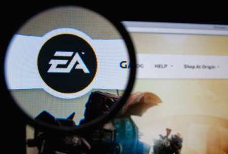 LISBON, PORTUGAL - MARCH 13, 2014: Photo of Electronic Arts homepage on a monitor screen through a magnifying glass.のeditorial素材