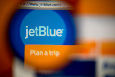 LISBON, PORTUGAL - AUGUST 27, 2014: Photo of JetBlue Airways homepage on a monitor screen through a...
