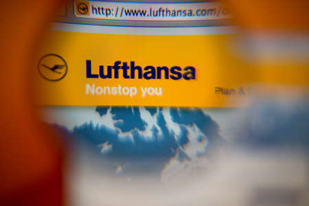 LISBON, PORTUGAL - AUGUST 27, 2014: Photo of Lufthansa German Airlines homepage on a monitor screen through a magnifying glass.のeditorial素材