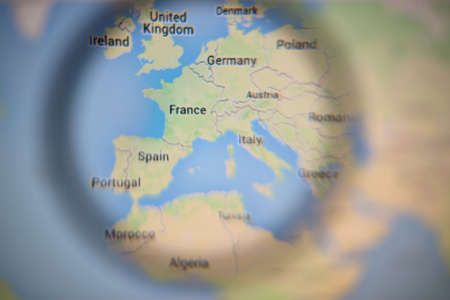LISBON, PORTUGAL - AUGUST 27, 2014: Photo of Photo of Europe on Google Maps on a monitor screen through a magnifying glass.のeditorial素材