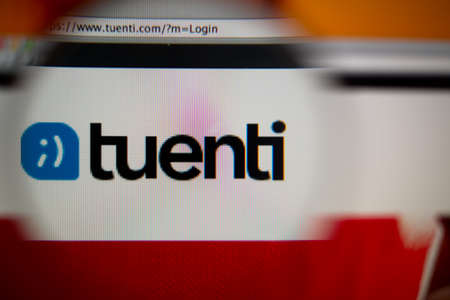 LISBON, PORTUGAL - AUGUST 27, 2014: Photo of Tuenti homepage on a monitor screen through a magnifying glass.のeditorial素材