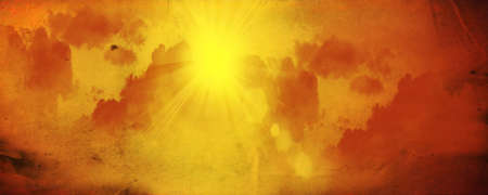 Brilliant orange sunrise over clouds with bright yellow sun on a cool spring morning.の写真素材