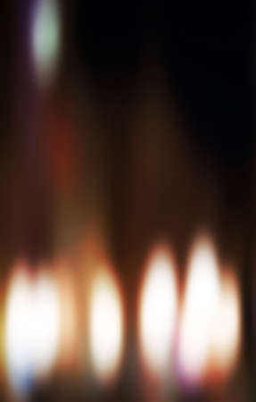 Candles light. Christmas candles burning at night. Abstract candles background. Golden light of candle flame.の写真素材