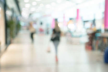 Blur store with bokeh background. Silhouettes of Business People in Blurred Motion Walking. Business people walking in the office corridor.の写真素材