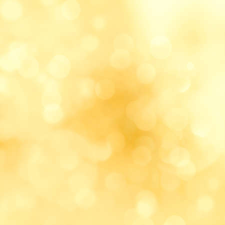 Golden sparkle glitters with bokeh effect and selectieve focus. Festive background with bright gold lights, orange bubble. Luxury Christmas mood concept. Copy space, close up, texture, top view.の写真素材