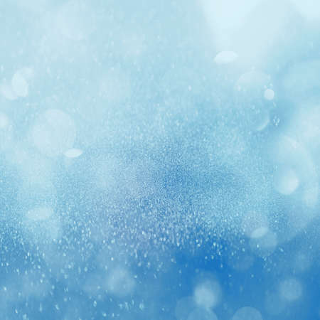 Christmas glowing blue Background. Christmas lights. blue Holiday New year Abstract Glitter Defocused Background With Blinking Stars and sparks. Blurred Bokehの写真素材