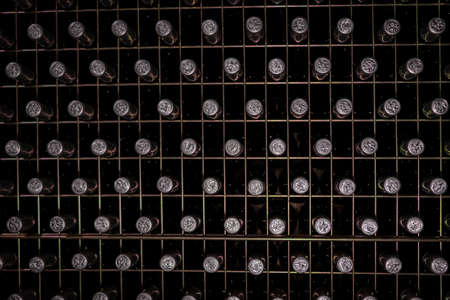 wine bottles stacked in wine cellar