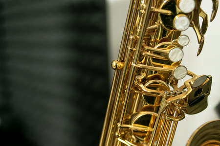 Close-up of the keys of a golden and shiny tenor sax where you can see the constructive details of the musical instrument and its complexityの写真素材