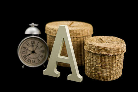 Set of 2 wicker baskets with an alarm clock and the letter A uppercaseの写真素材