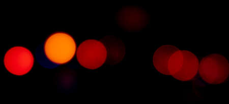 Flashes of orange and red lights on black background