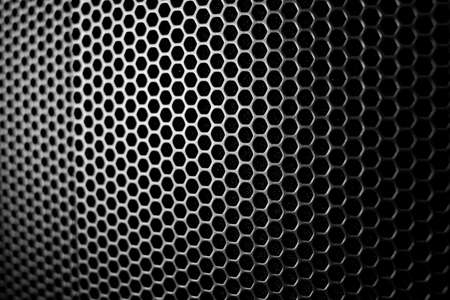 Satin and black metal grid macro protecting an amplifier as a wallpaper