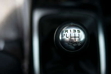 Close up view of a gear lever shift. Manual gearbox. Car interior details. Car transmission. Soft lighting. Abstract view. European carの写真素材