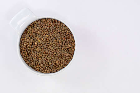 white bowl of lentils on white background