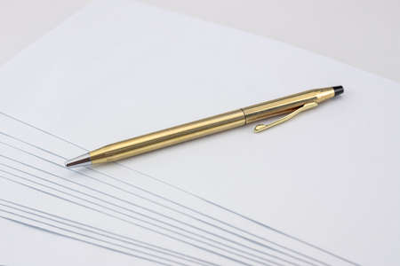 Golden and shiny pen on white envelope set