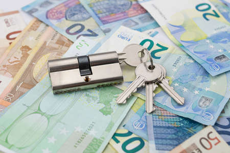 Keychain with lock on a background of varied euro bills