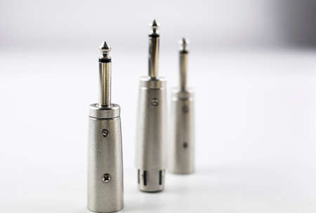 jack type metal audio connectors with balanced male and female canon inputs on white backgroundの写真素材