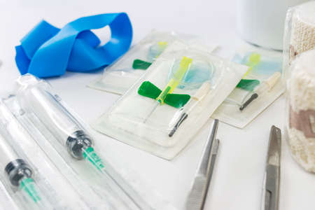 Compression band vials, syringes, tweezers, scissors and tape for emergency medical assistance in a nursing roomの写真素材