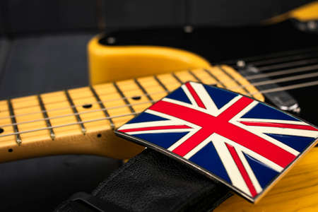 American classic electric guitar with metallic clasp of the British flag "Union Jack" on the strapの写真素材