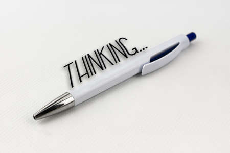 A blue and white pen with silver tip on white backgroundの写真素材