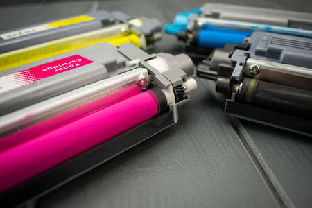 Close-up of magenta toner cartridge along with other yellow, black and cyan for laser printer