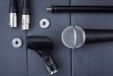Microphone with stand, lock washers and xlr connectors on wooden table, in complete kit
