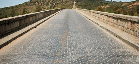 Cobbled road over stone bridge of Hispanic Roman originの写真素材