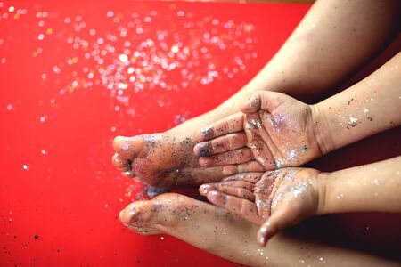 Christmas glitter on the feet and hands of a child