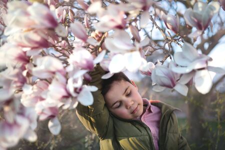 Boy and blooming magnolia.